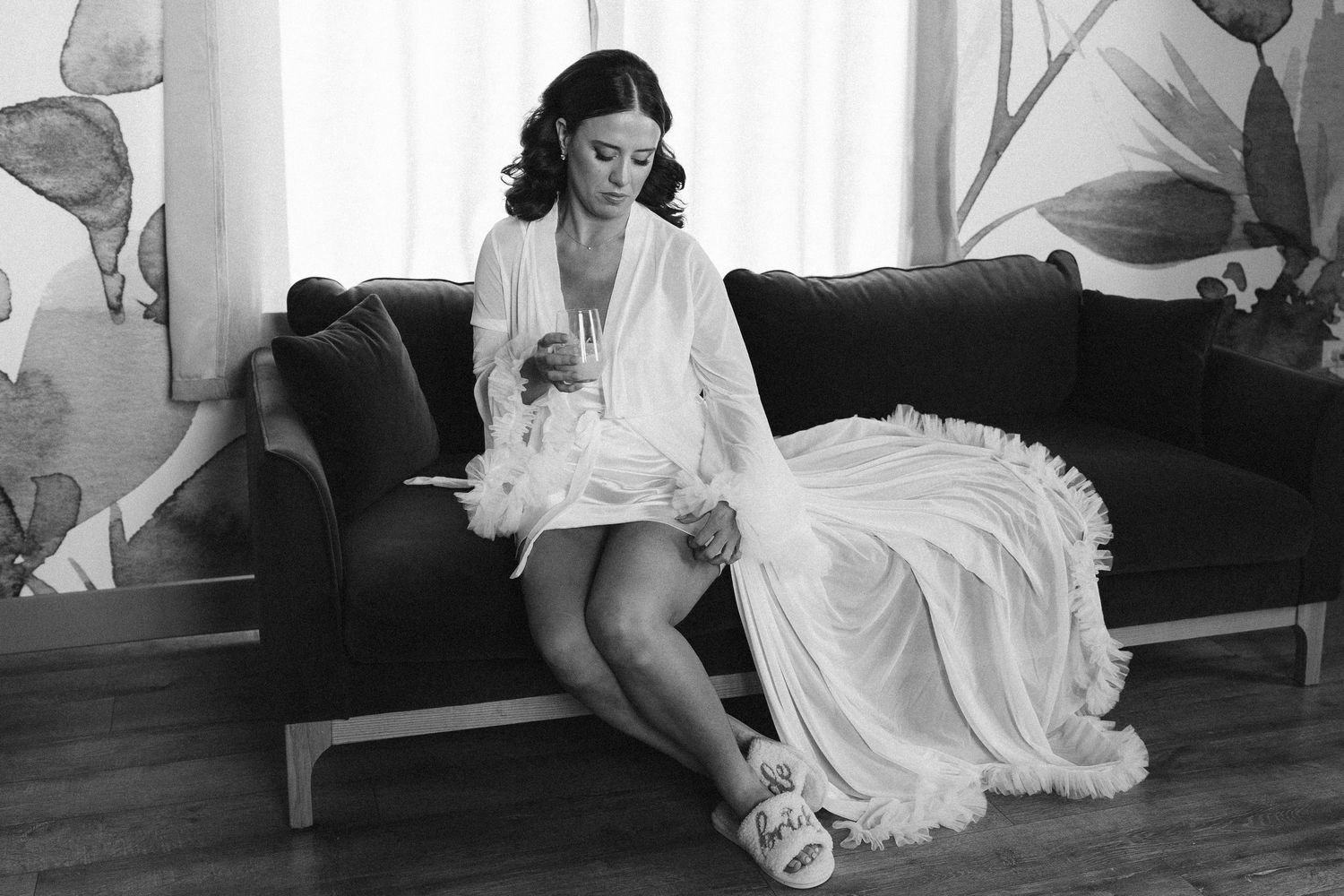 Black and white wedding photo series showing candid moments in a studio setting.