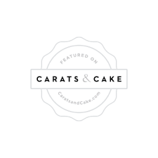 Simple black and white circular logo design for Carats & Cake with stylized text in modern typography.
