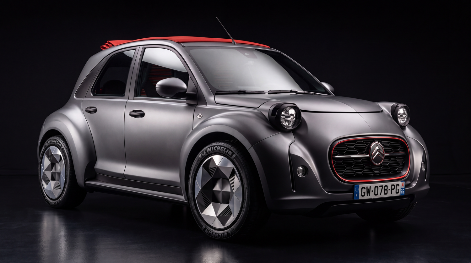 A modern silver concept car with round headlights and sleek styling is displayed against a red background with magazine covers.