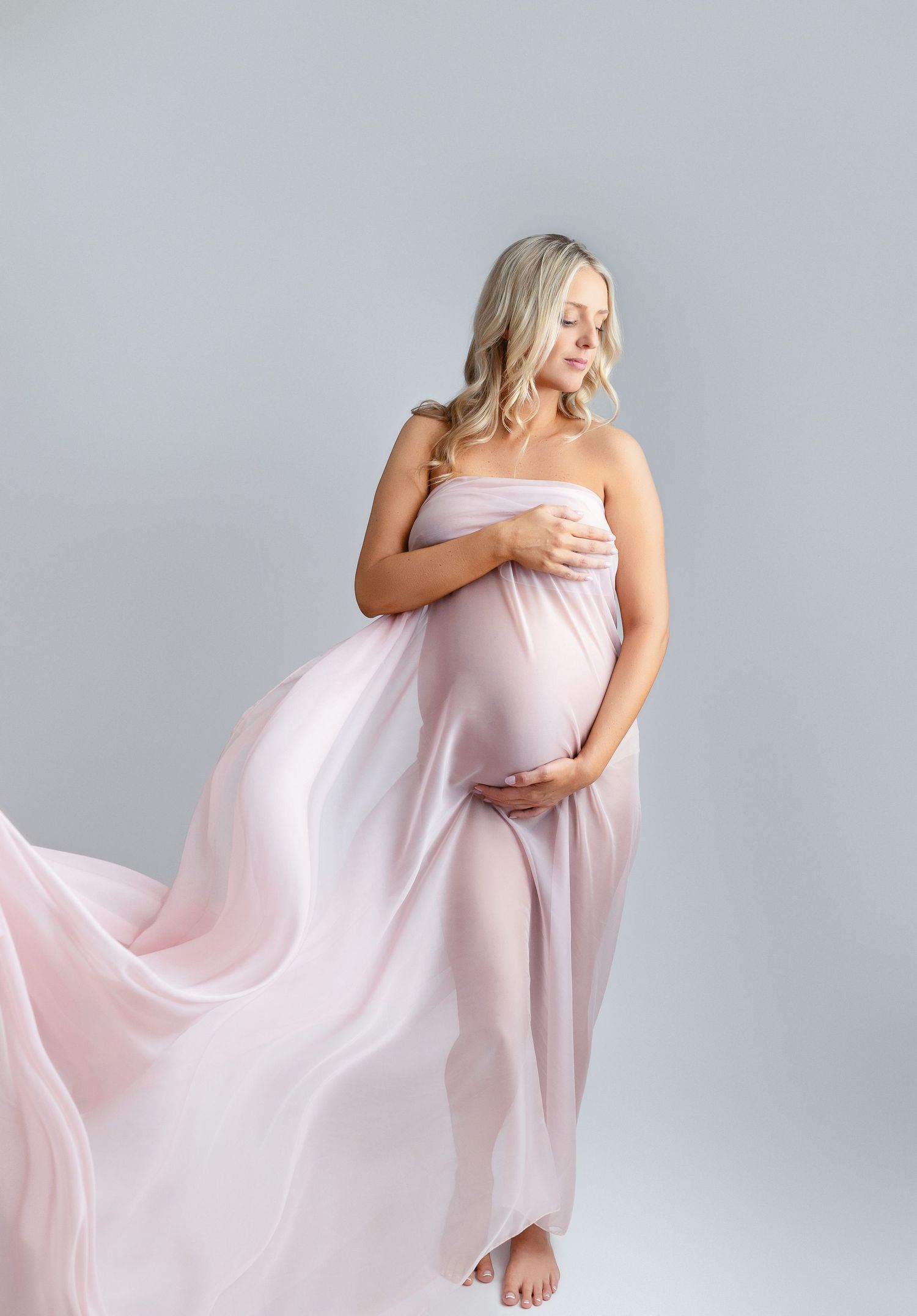 Beautiful mom with a pink layer flowing at her maternity session. Greenville SC newborn photographer, Easley SC newborn