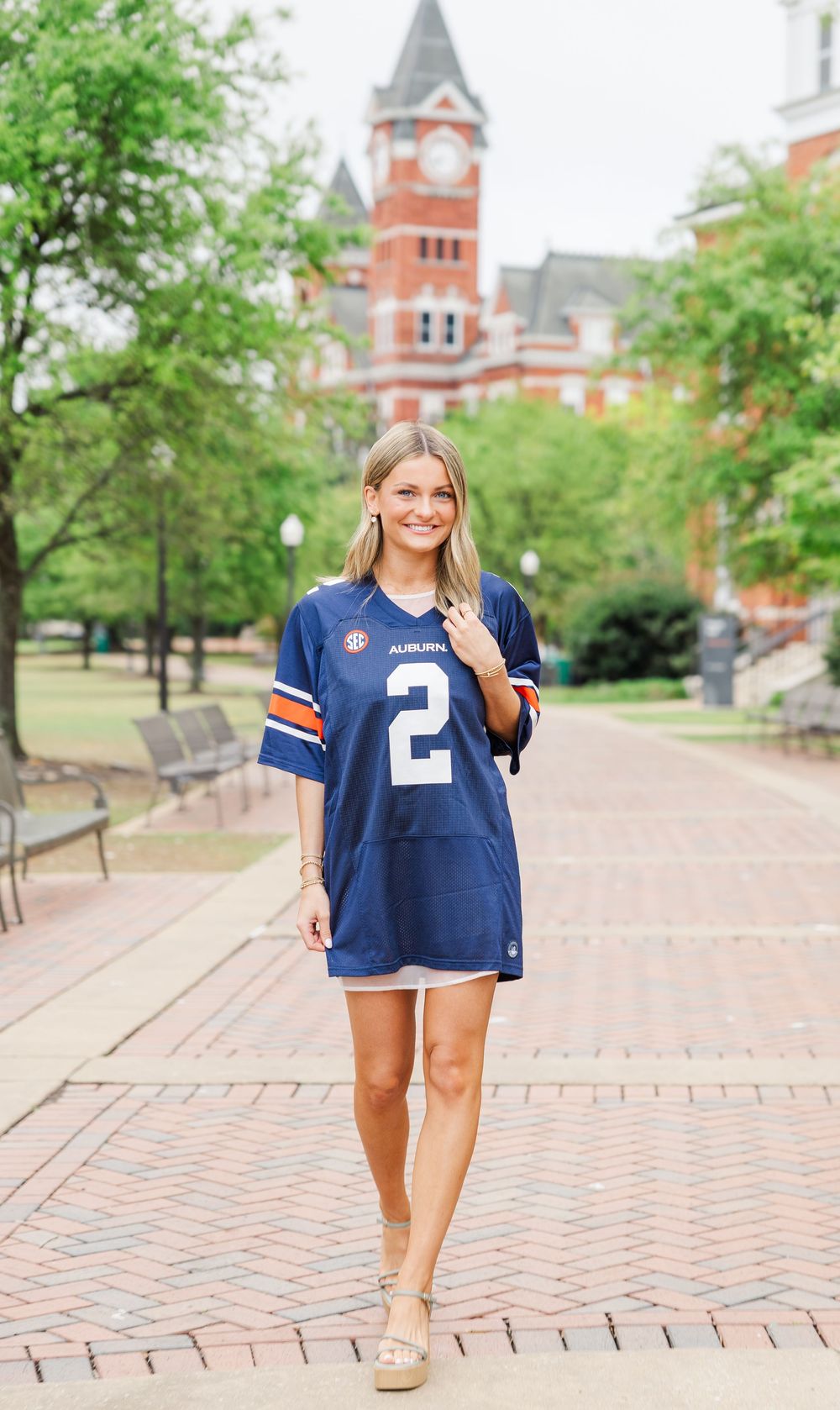 Auburn University campus walkway with historic Samford Hall clock tower building in the background.