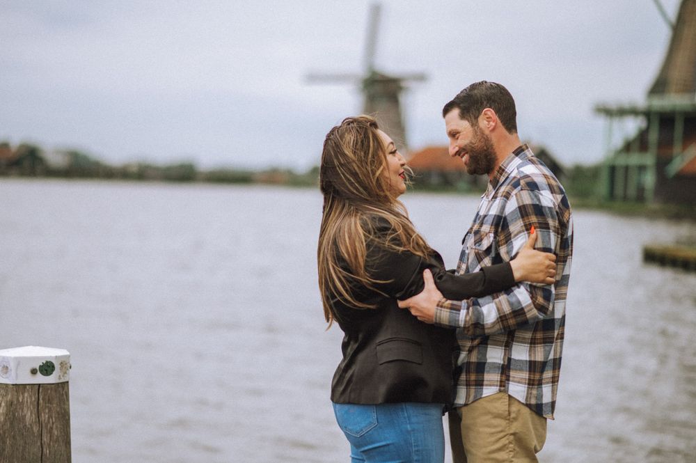 A romantic sequence by a windmill and water landscape.