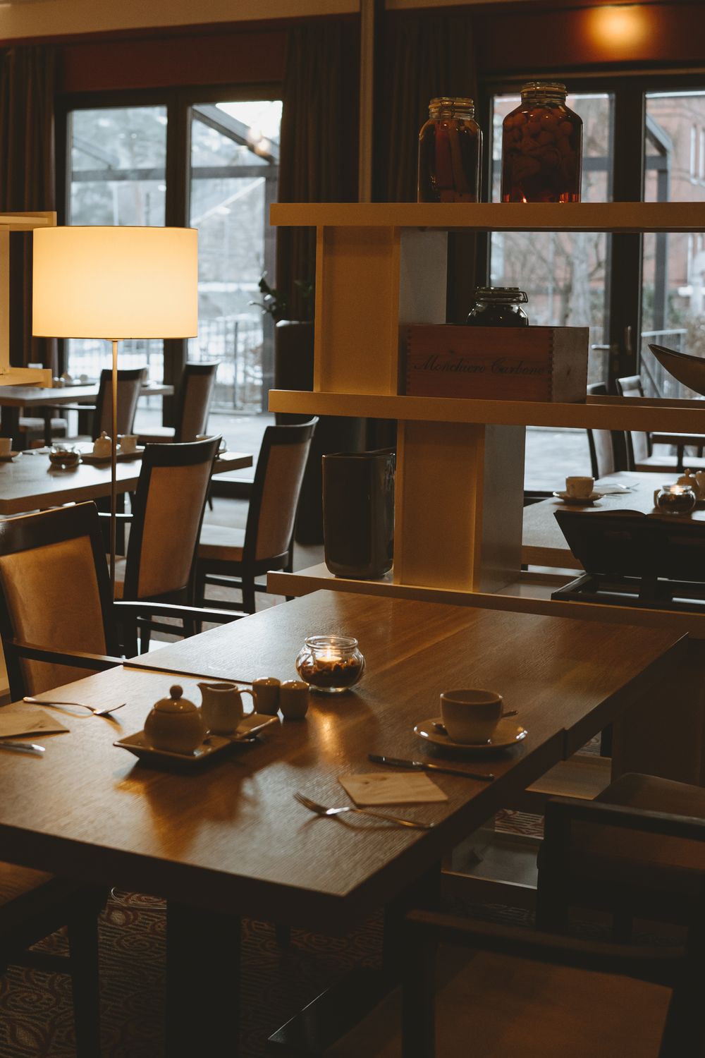 Warm and inviting hotel restaurant interior with wooden tables and ambient lighting.