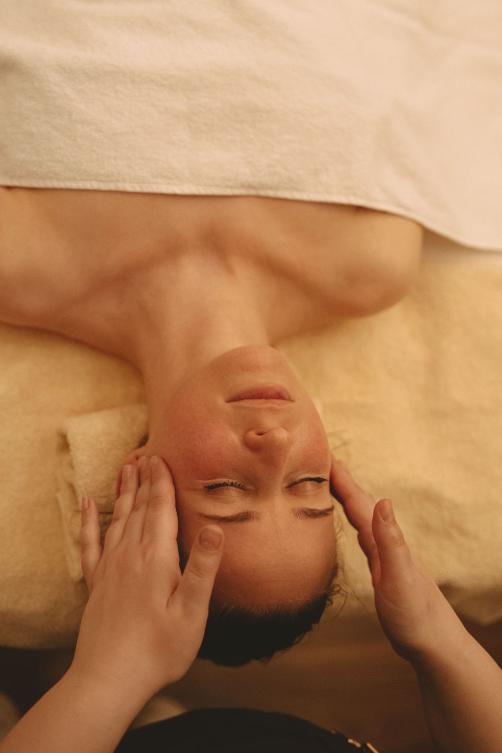 Closeup of a relaxing spa facial massage treatment.