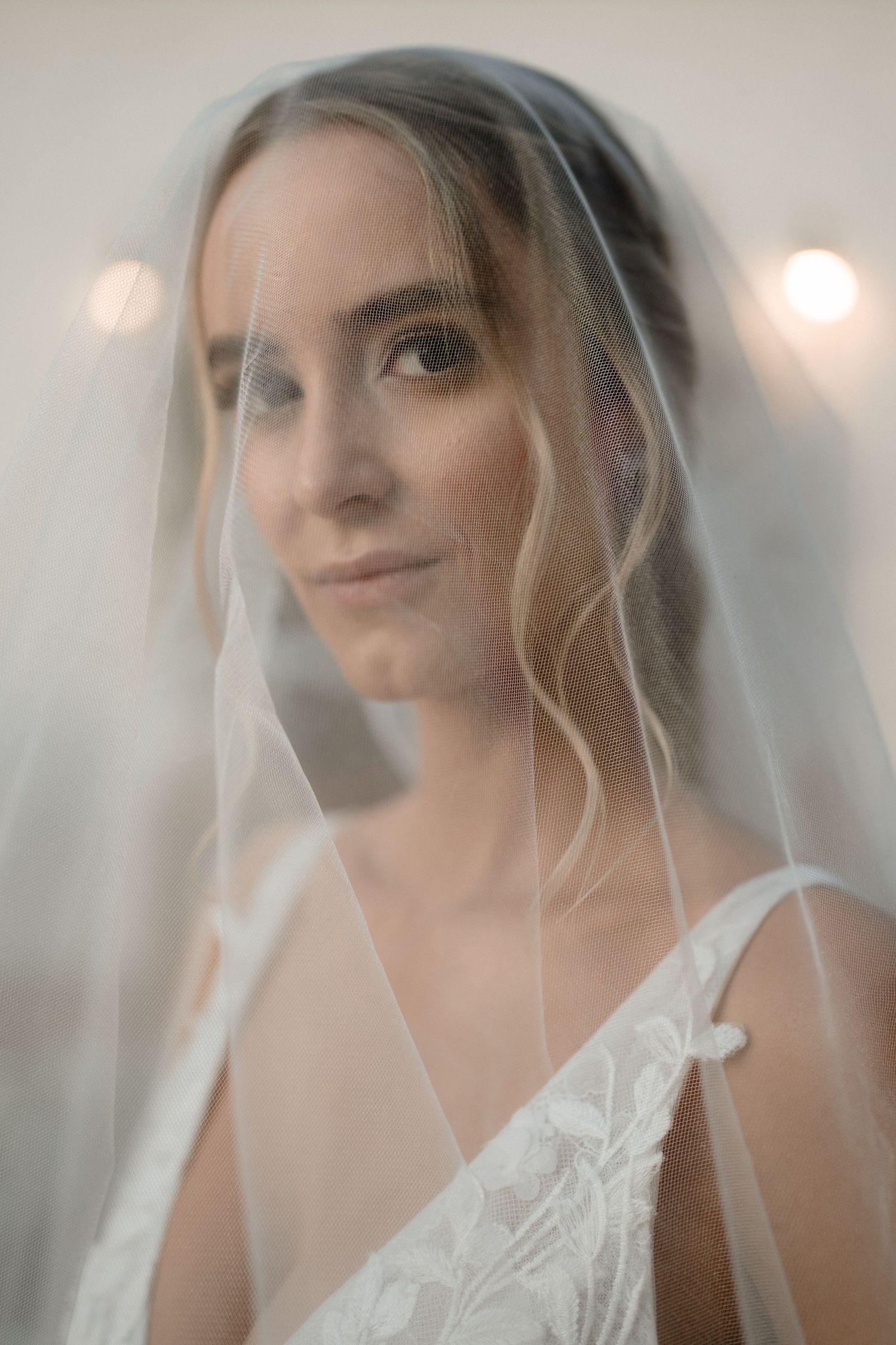 A black and white wedding photo series showing a bride in a flowing white gown and groom in a dark suit outdoors.