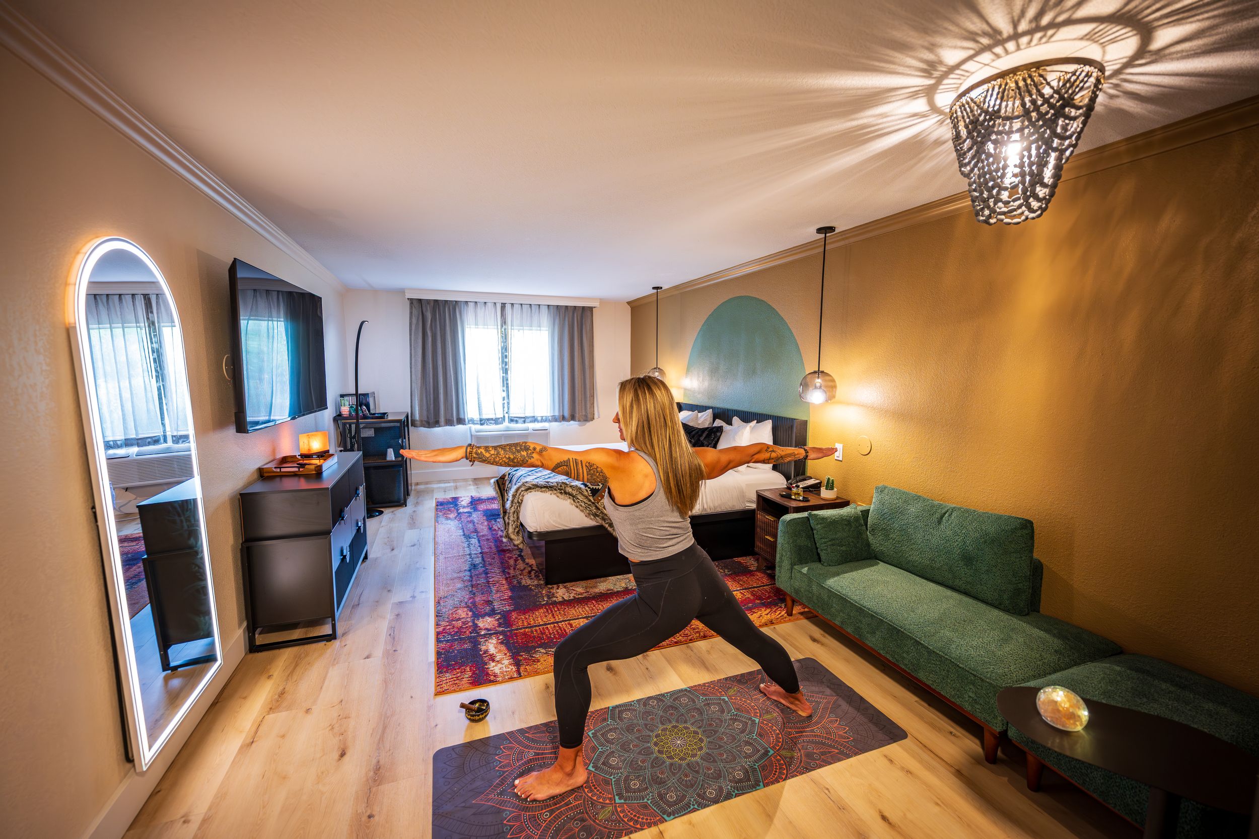 Woman doing yoga in her room at a luxury hotel, the Arroyo Pinion Hotel in Sedona, AZ.