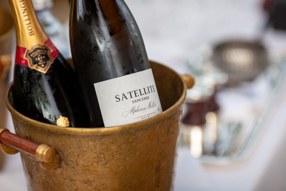 Satellite Sancerre wine bottle chilling in a rustic copper ice bucket at an elegant table setting.