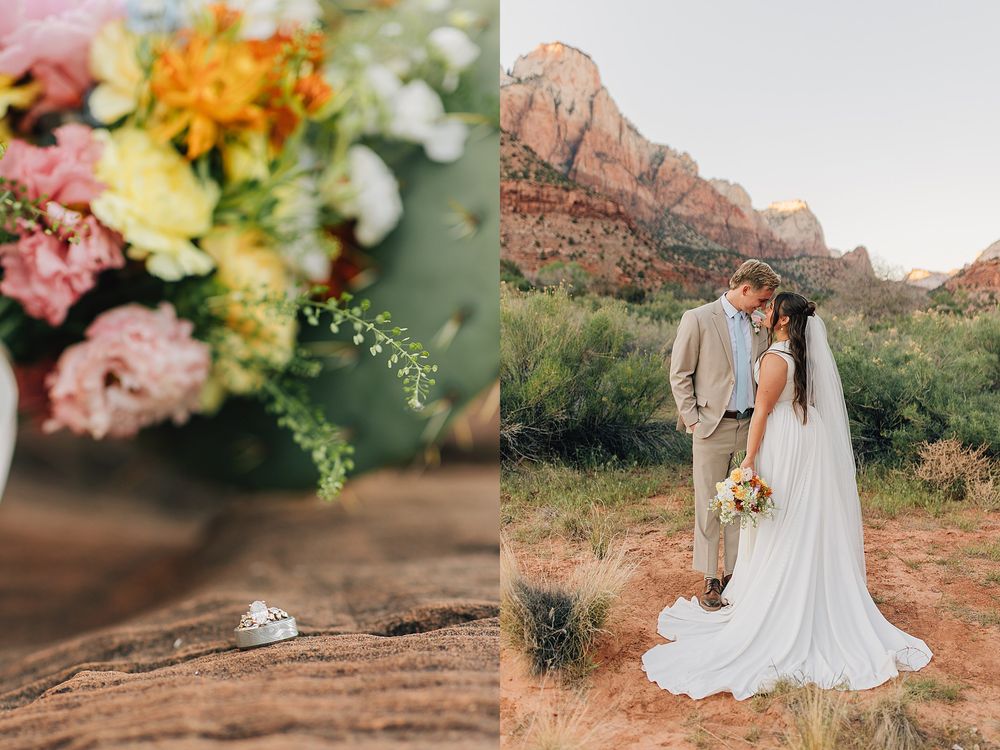 Bride and groom embrace in Zion National Park with red rock mountains, beside a colorful bouquet and wedding rings on wood.