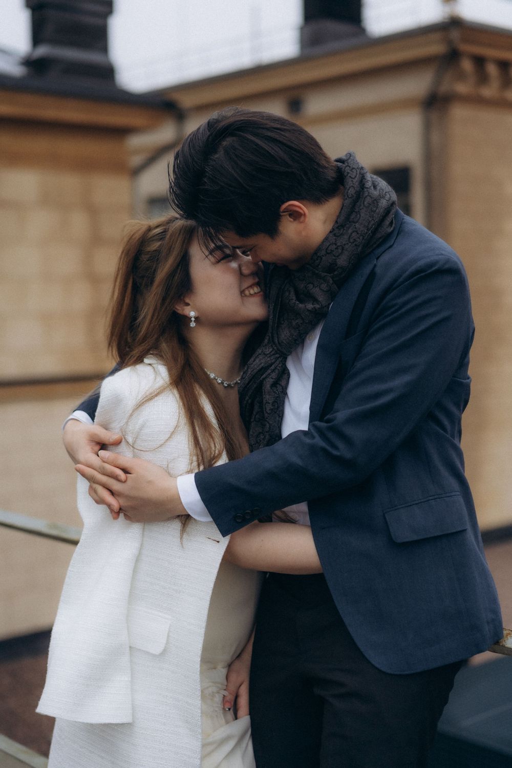 Romantic engagement portrait of a couple embracing near Helsinki Cathedral in Helsinki