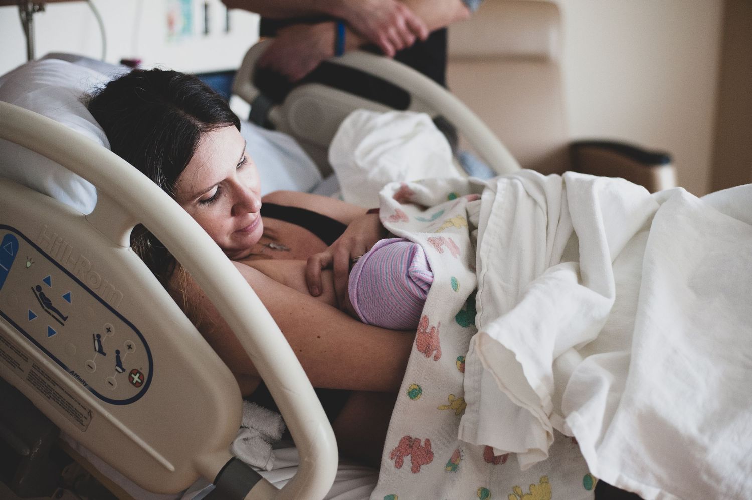 A peaceful moment of rest with newborn in a modern hospital delivery room.
