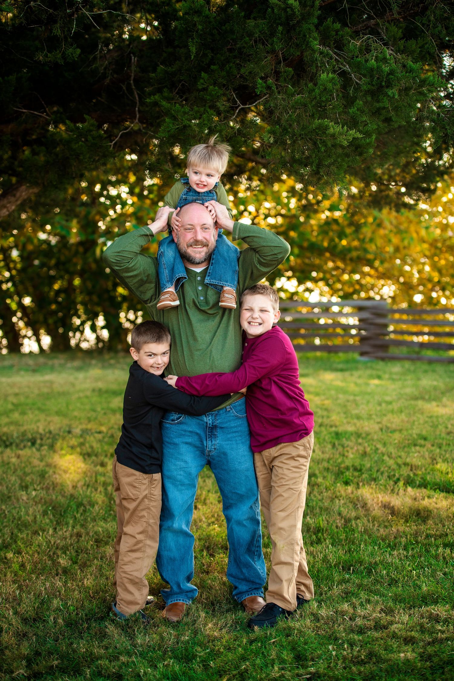 Playful outdoor family portrait showing intergenerational bonding on a sunny autumn day.