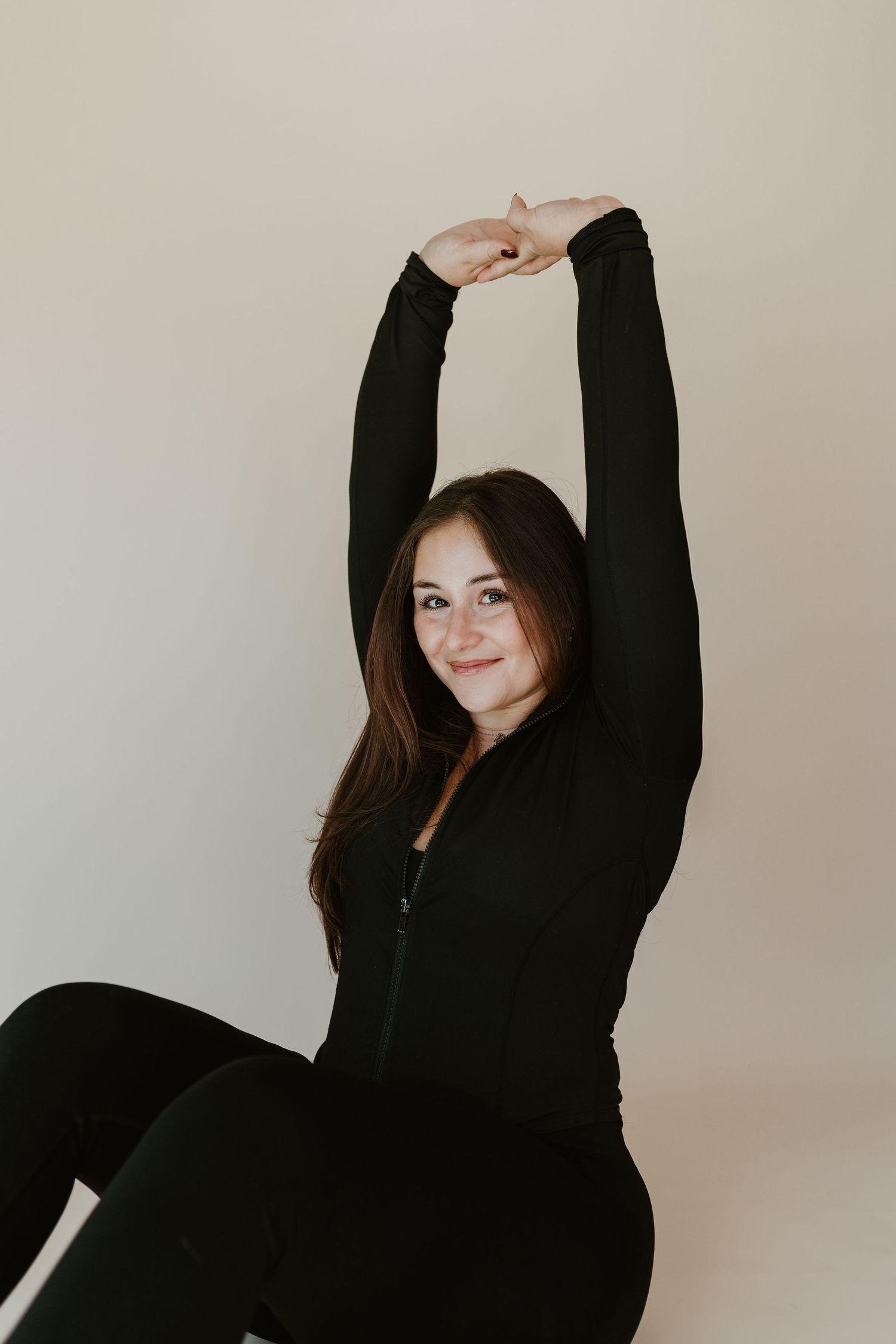 Branding photoshoot in Spartanburg South Carolina taken by Photos by Allii. Woman is stretching her arms over her head while smiling