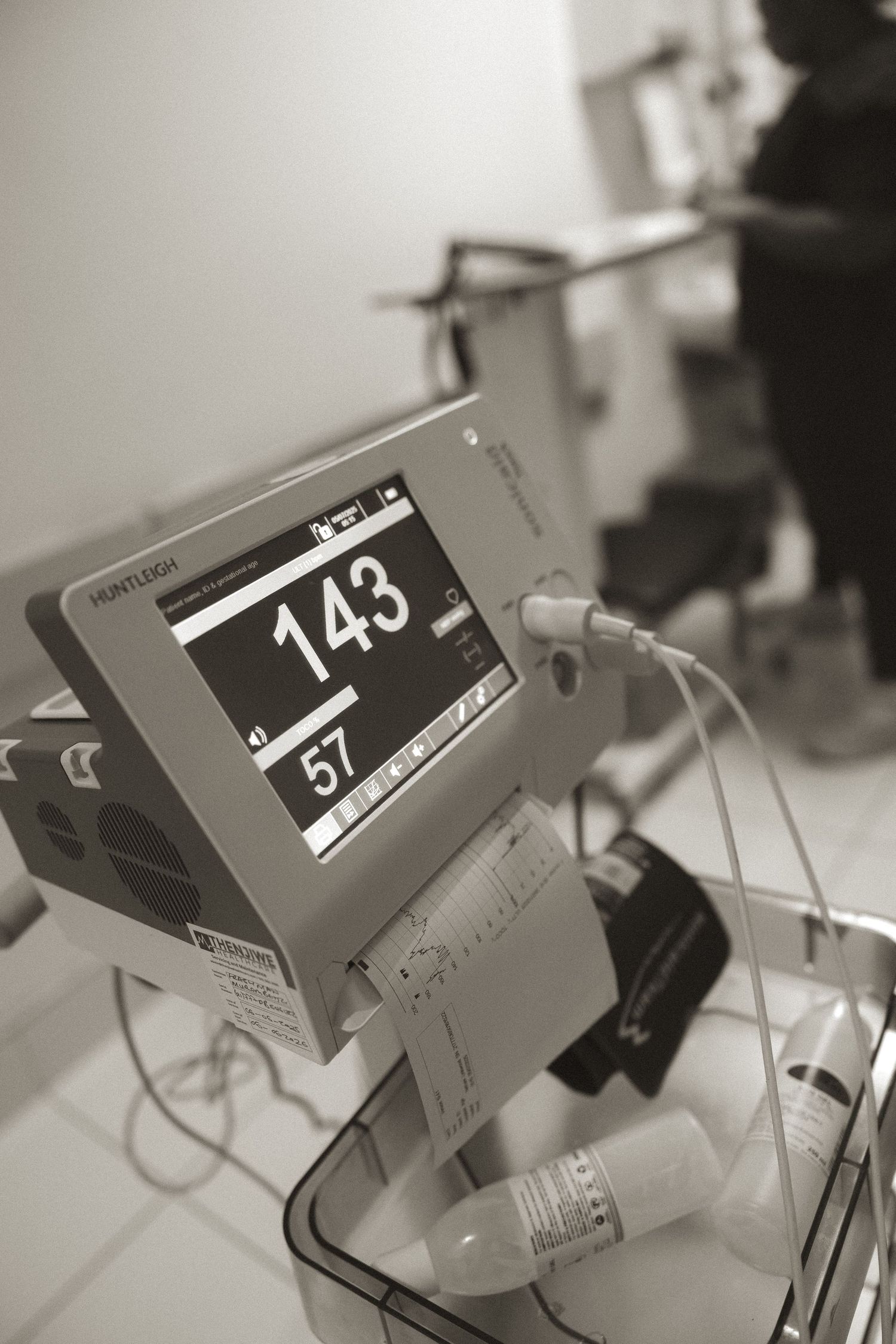 Digital display showing numerical readouts in black and white tones with blurred background elements.