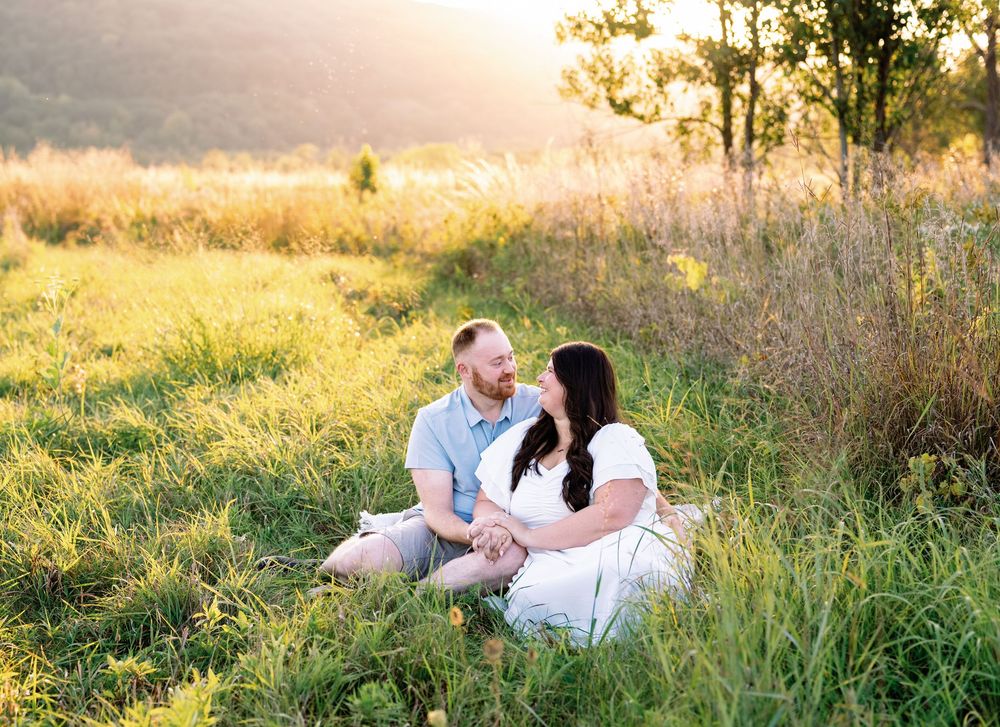 A romantic sunset engagement photo session in a golden meadow.