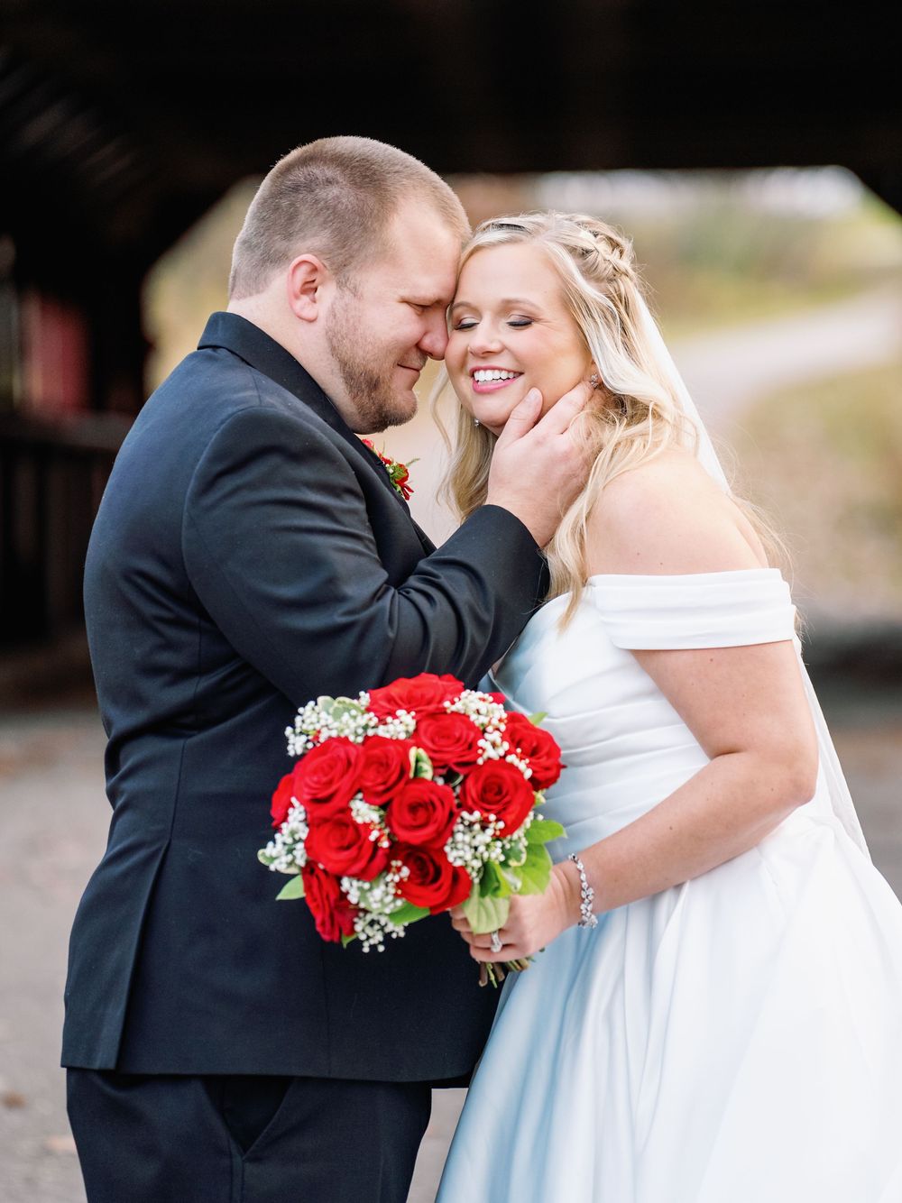 A romantic wedding photo series showing tender moments between newlyweds with a vibrant red bouquet.