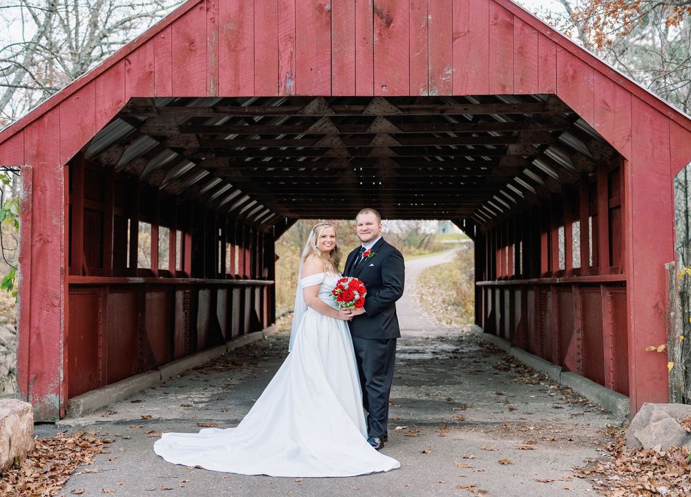 A series of wedding photos taken under a rustic red covered bridge.