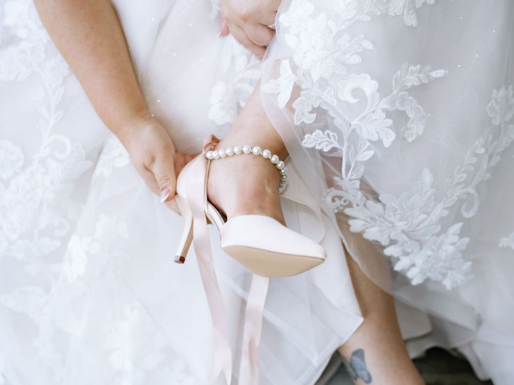 Detail shots of a bride's lace wedding dress and accessories.