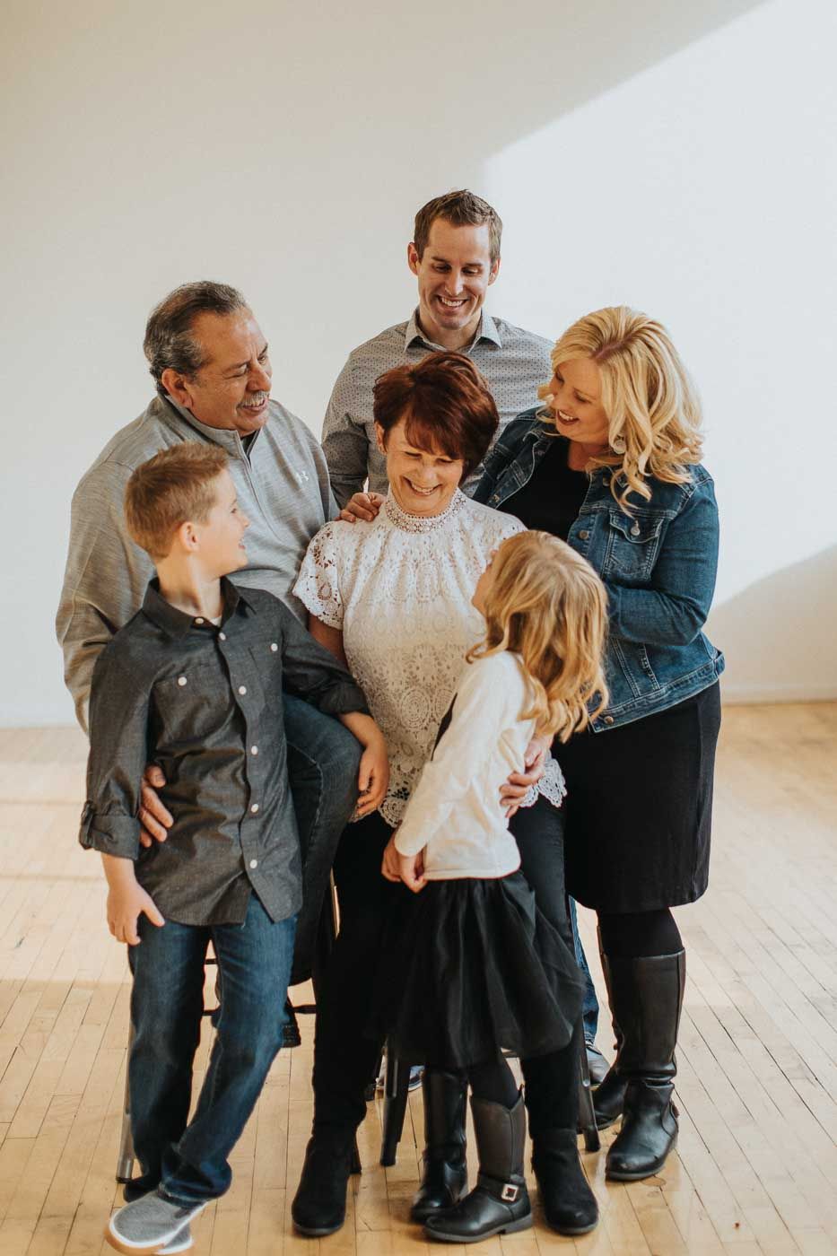 A multigenerational family shares a joyful moment together in a bright indoor setting.