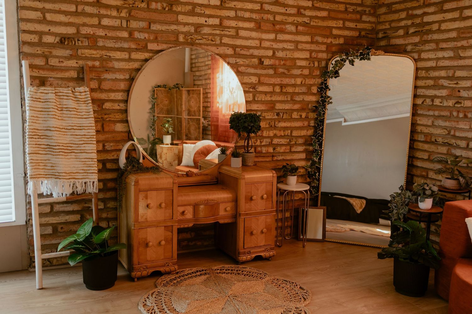 A cozy rustic living room with exposed brick walls, wooden furniture, and natural lighting from windows.