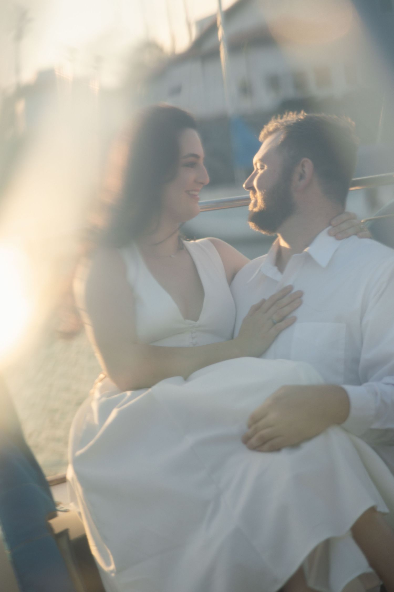 Engagement session on a sailboat in Ventura with a couple enjoying the ocean setting