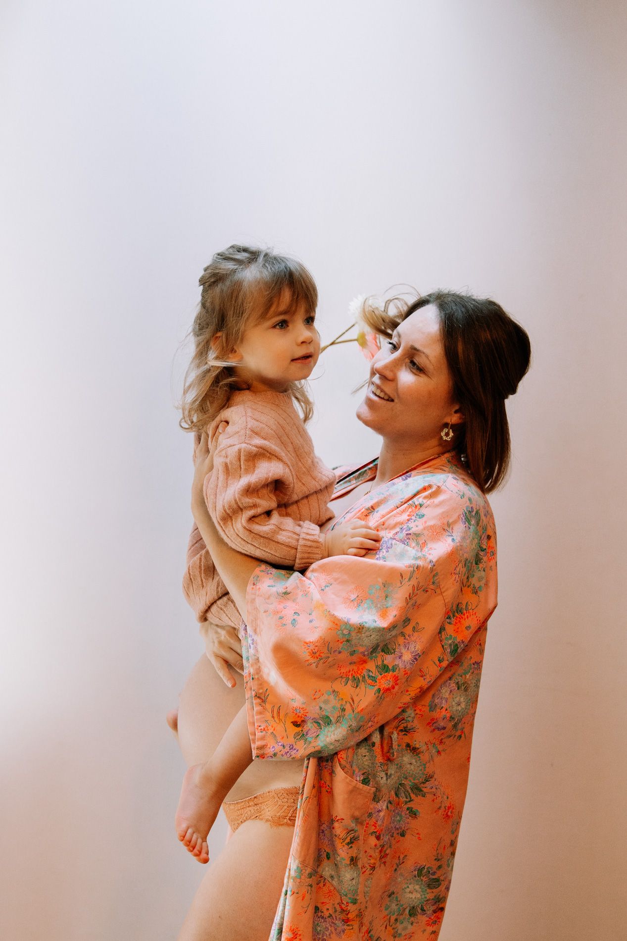 A joyful moment captured in a series of photos showing playful interaction between parent and child in warm lighting.