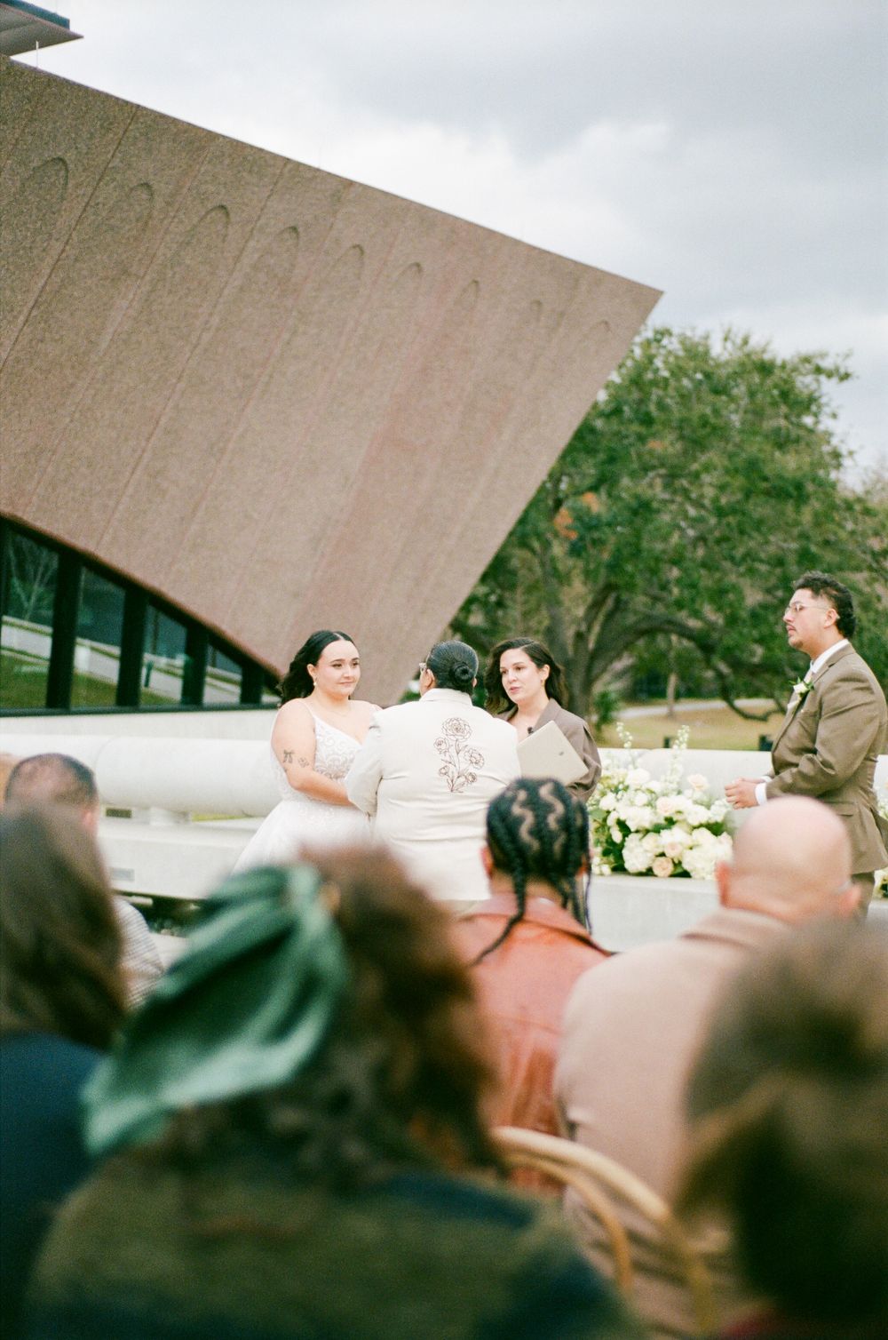 A series of blurry, panoramic shots showing people gathered outdoors with architectural elements in the background.