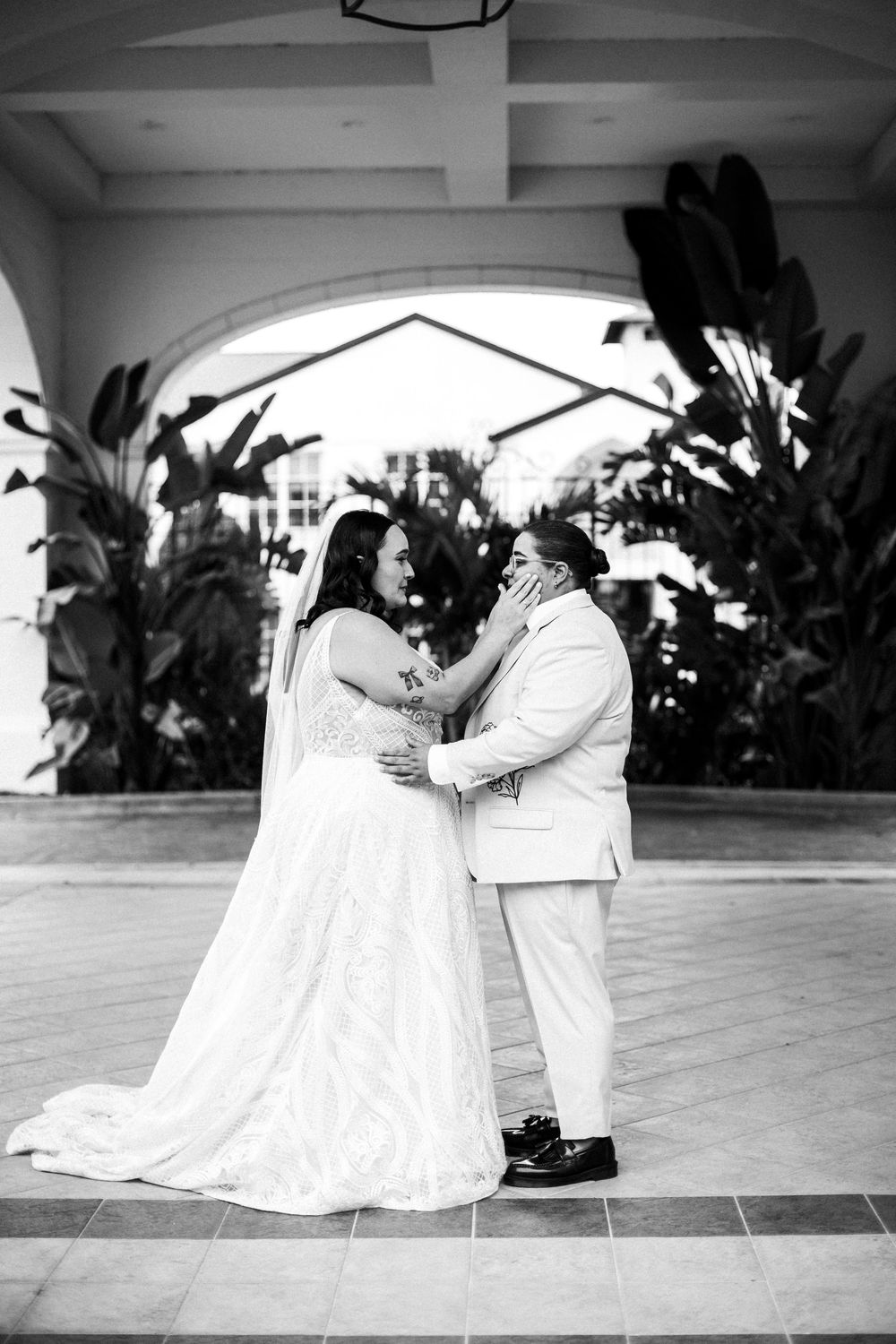 A romantic black and white photo series showing a couple in wedding attire dancing on a tiled floor.