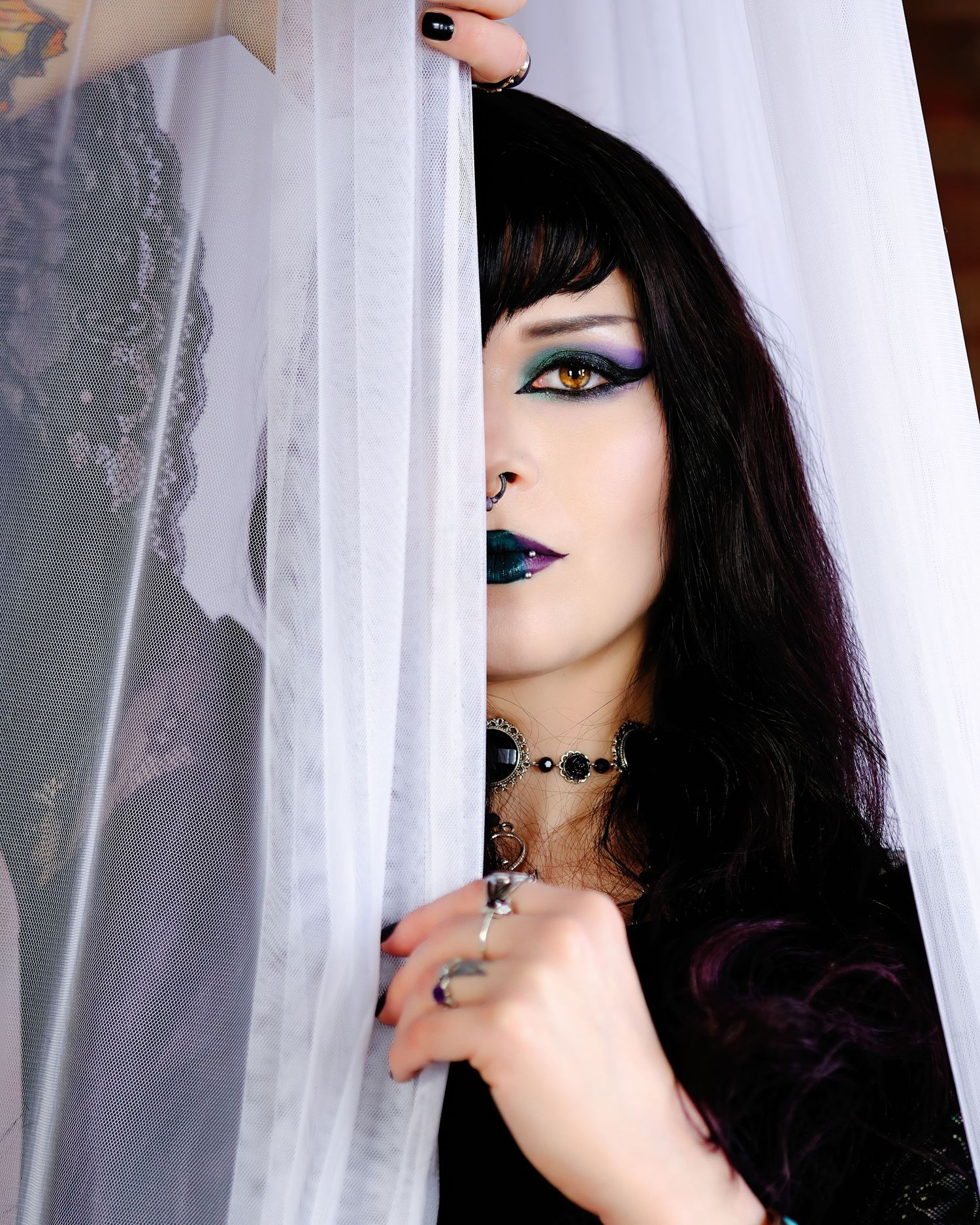 David G Holt Photography - Gothic style portrait with dramatic makeup peeking through white curtain.
