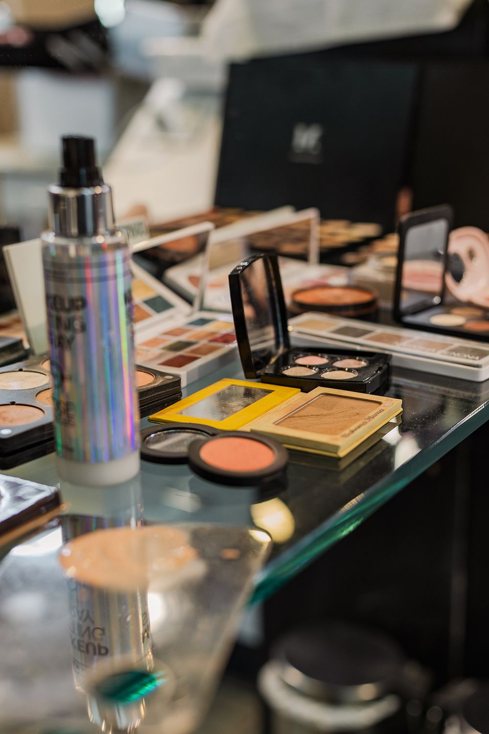Open makeup and sprays sitting on a table waiting for the bride in the morning in Kitchener, Ontario.