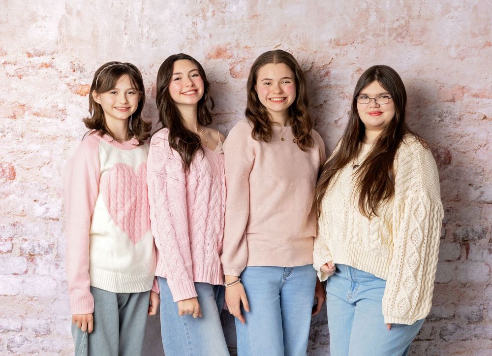 Group of teen best friends pose together brick backdrop during a studio session in NH