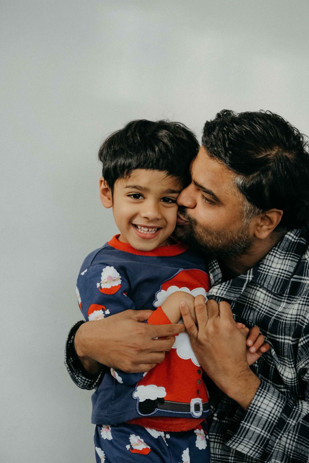 An autistic boy and his dad sharing a sweet moment during a family photoshoot in Northumberland
