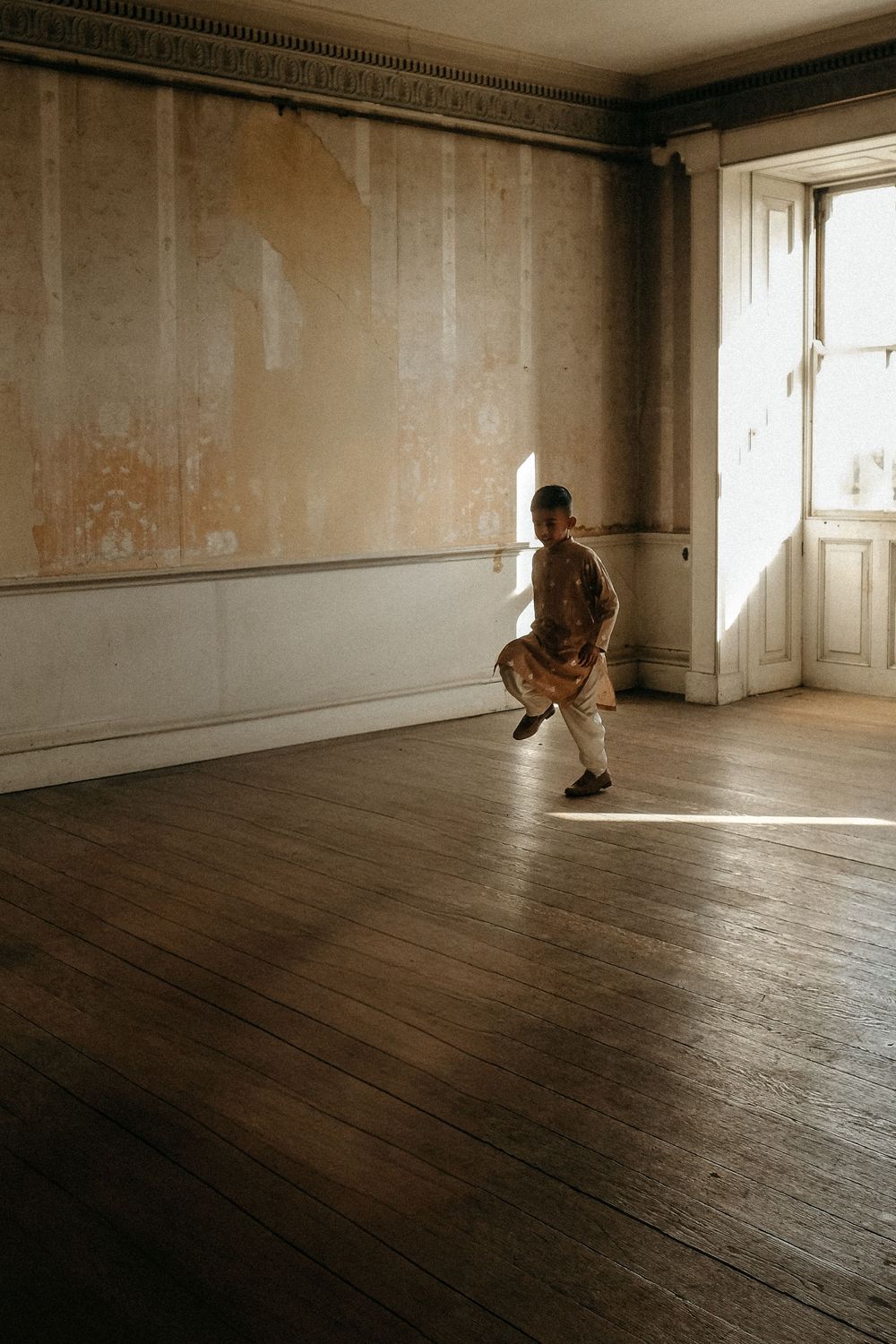 Natural light portrait of autistic child exploring the wide open spaces in Belsay Hall Northumberland