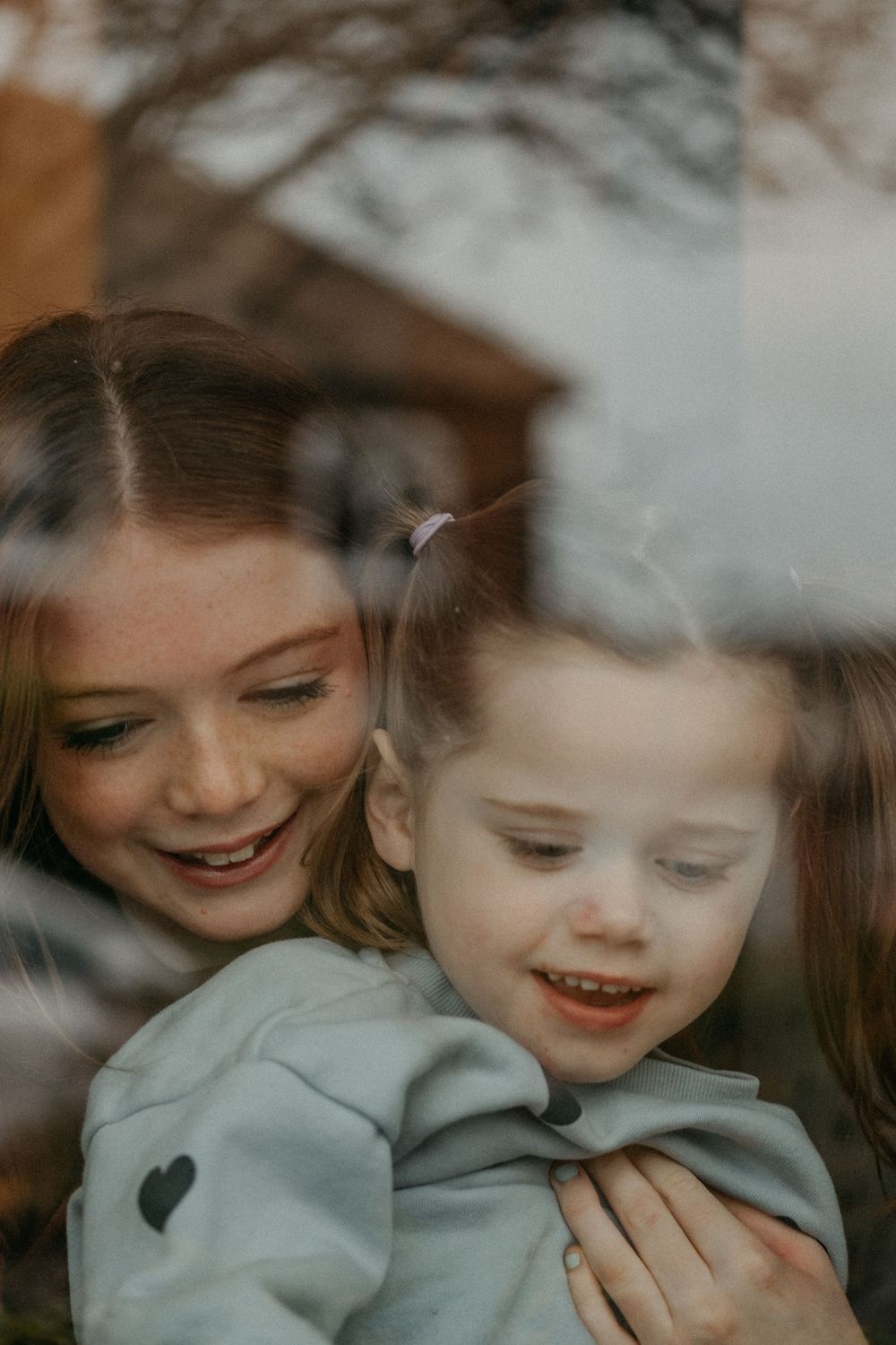 Tender moment between siblings during SEND-friendly photography session, autism specialist photographer North East