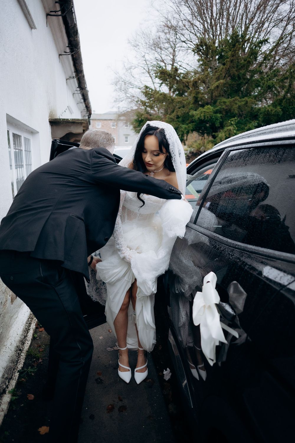 A sequence of photos showing someone helping a bride into a car while holding her white dress.