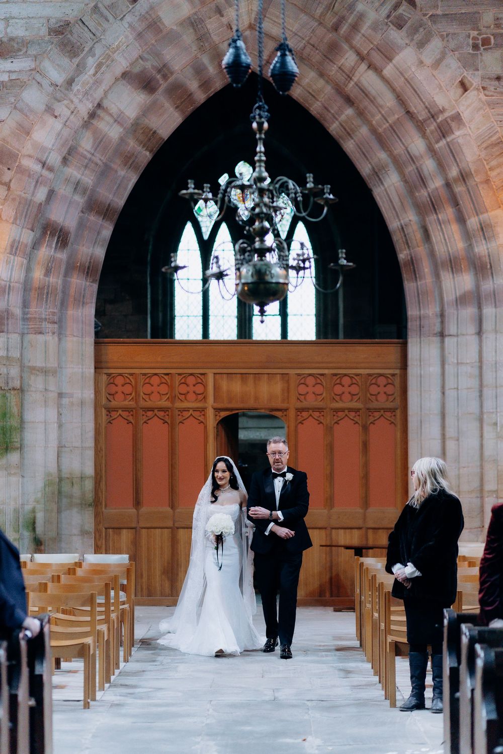 A sequence of wedding ceremony moments showing a processional through a stone church archway.