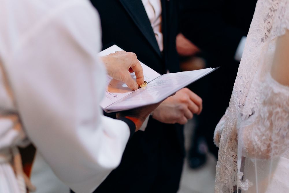 Intimate wedding ceremony moments in a church with soft lighting and traditional details.