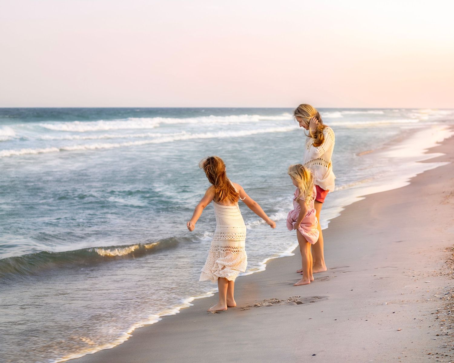 Mom and children looking at ocean on beach in Long Beach Island, NJ