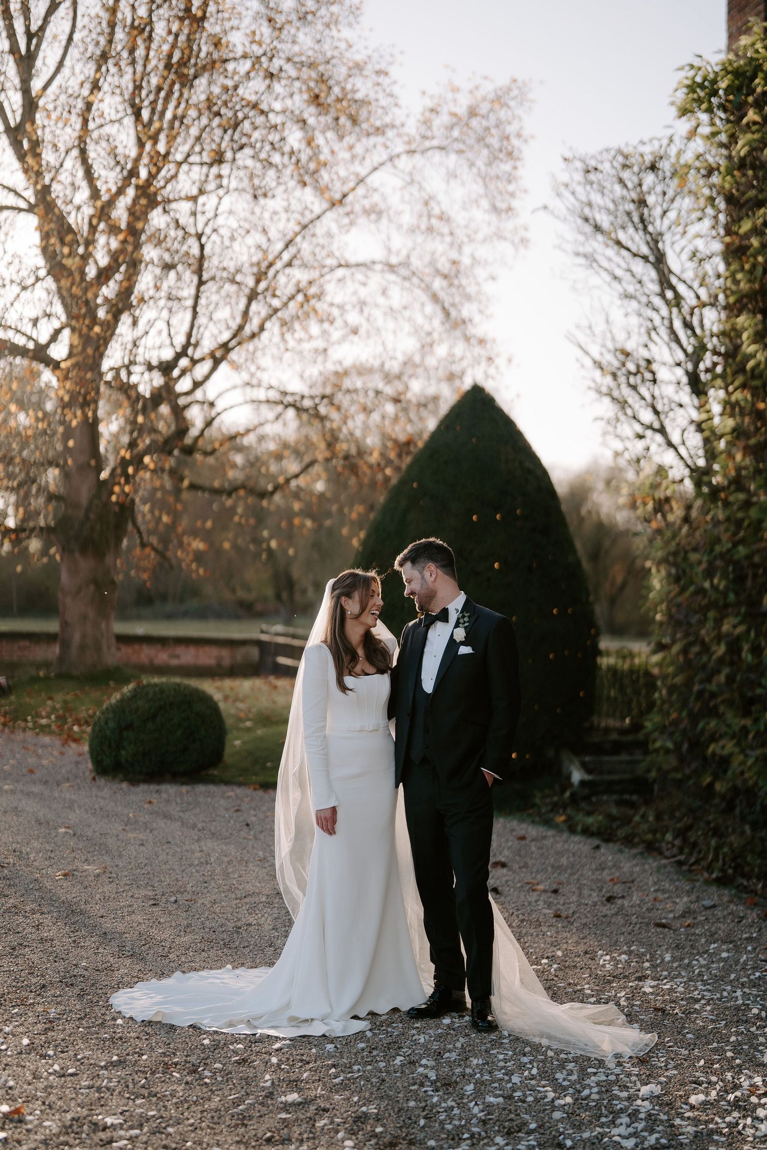 bride and groom smiling at each other outside Iscoyd park