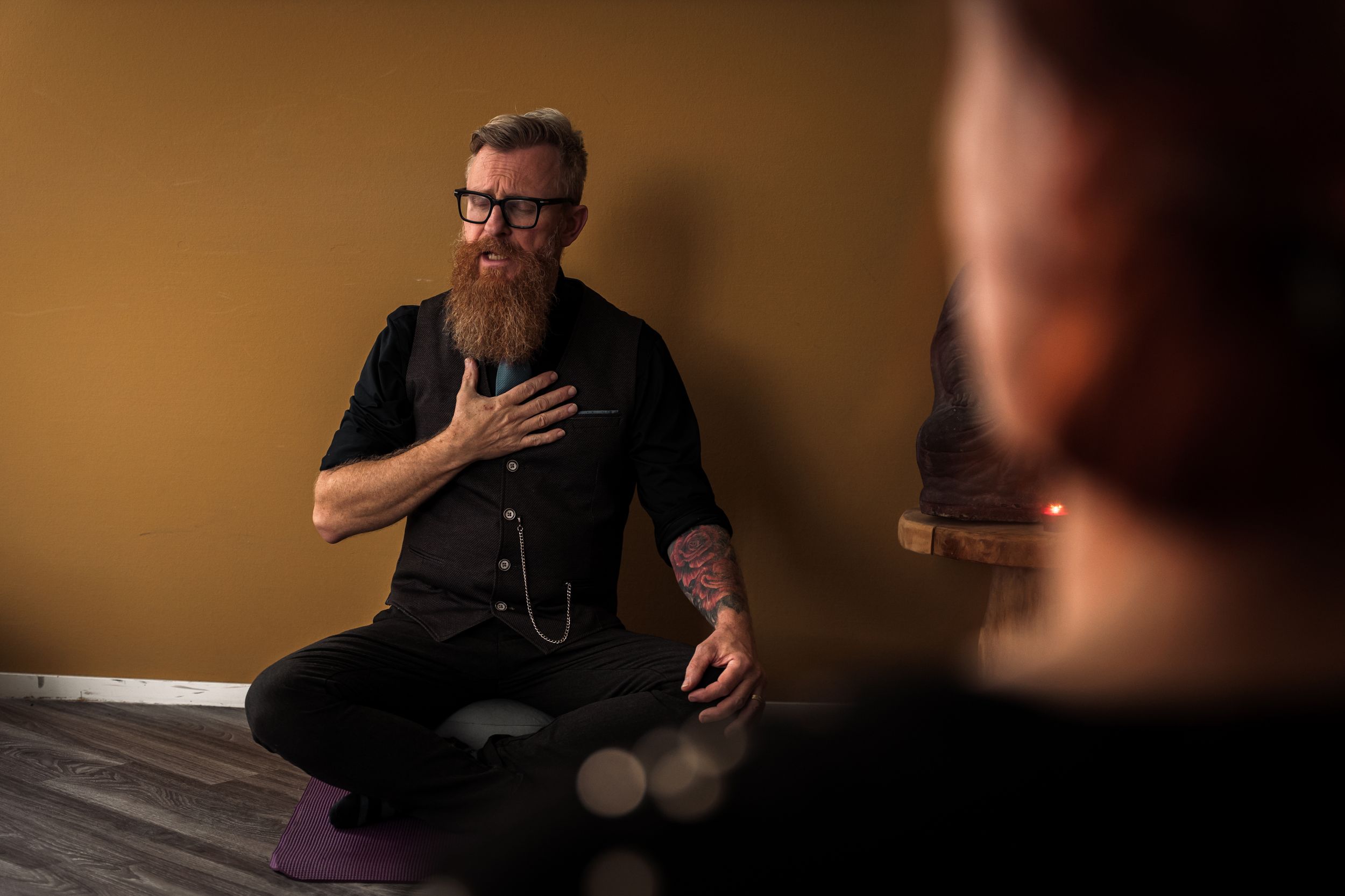 A sequence of six black and white photos showing someone in dark clothing sitting and gesturing during a conversation.