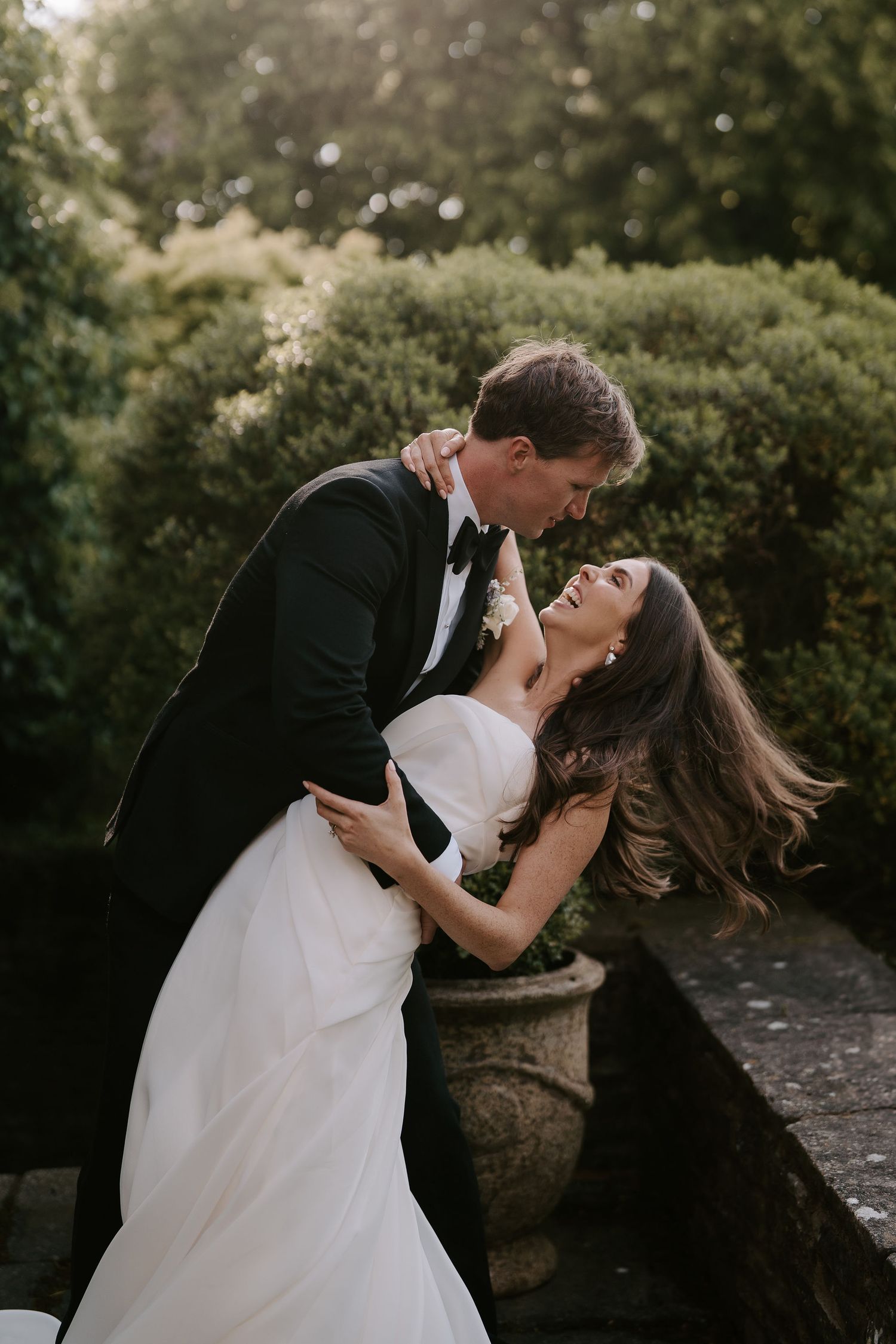 groom dipping laughing bride at dewsall court in herefordshire