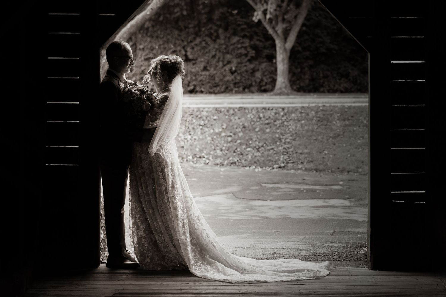 frederick county wedding photography Black and white artistic wedding portrait under rustic barn architecture.