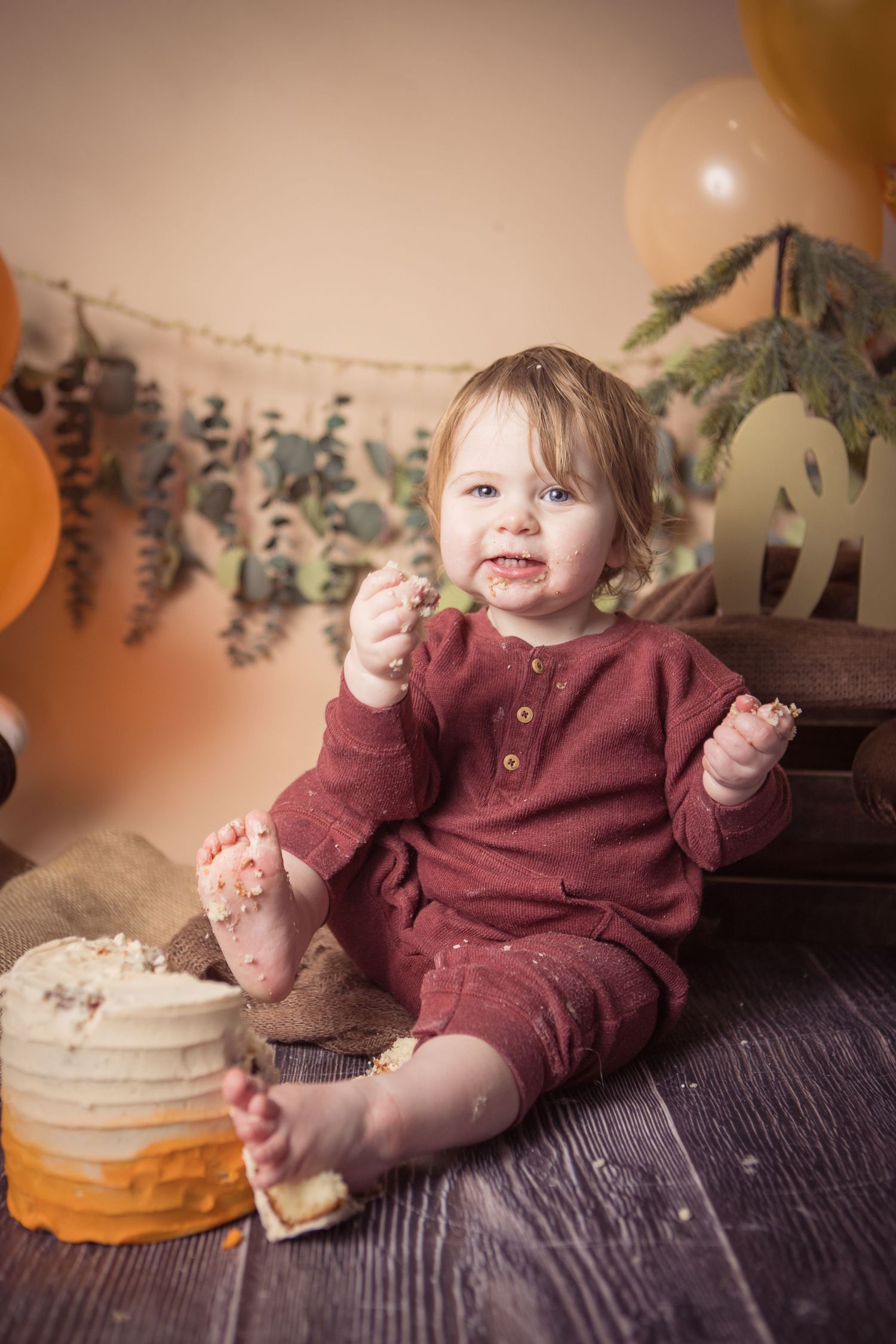A series of photos showing a small child in a burgundy sweater enjoying cake and treats on a dark wooden surface.
