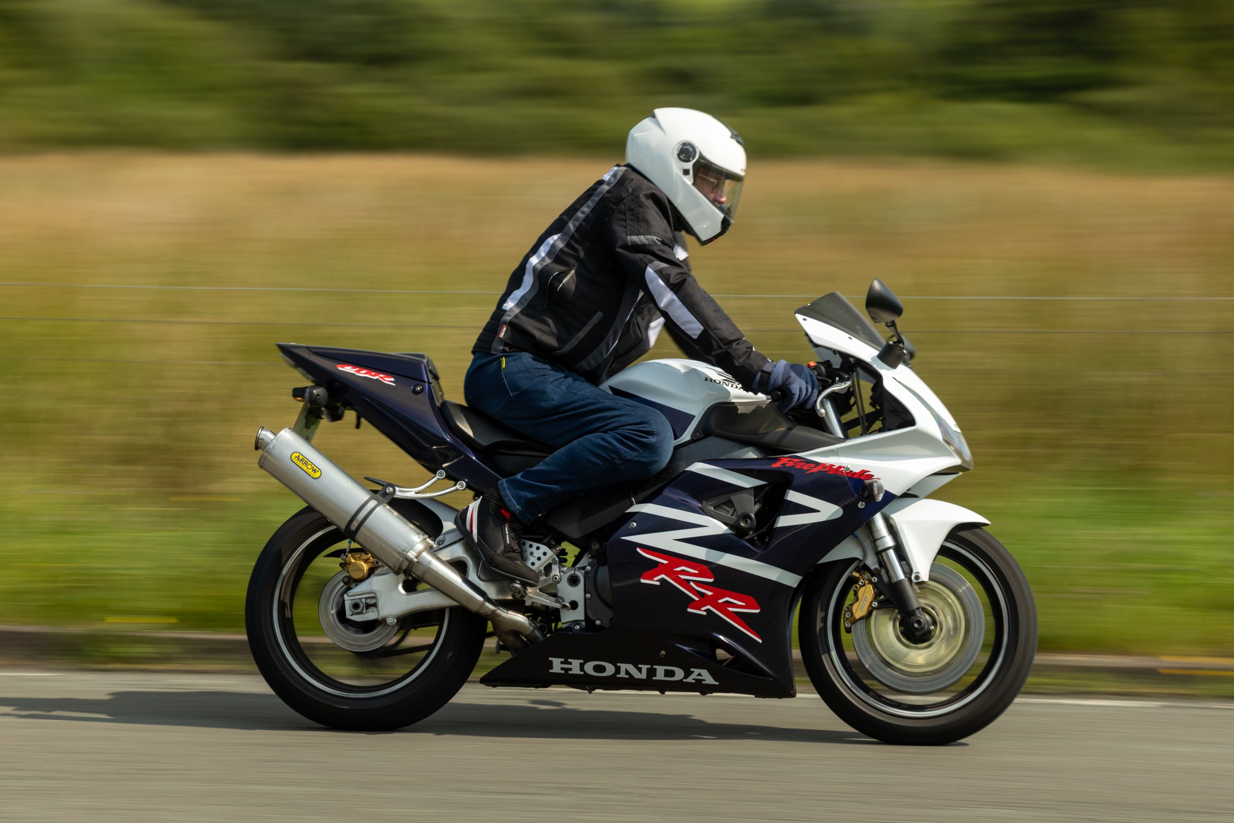 A sequence of motorcycle riders leaning into turns on a racetrack showing progressive racing positions and techniques.