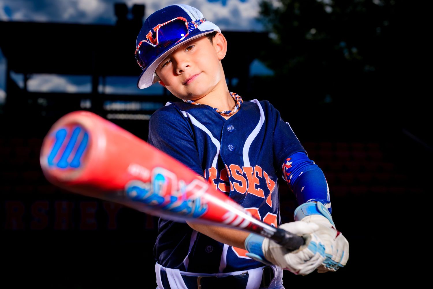 Little league all-stars baseball player pose at home plate with dramatic lighting by Deanna Fox, SportsFox Photography based in Hershey PA