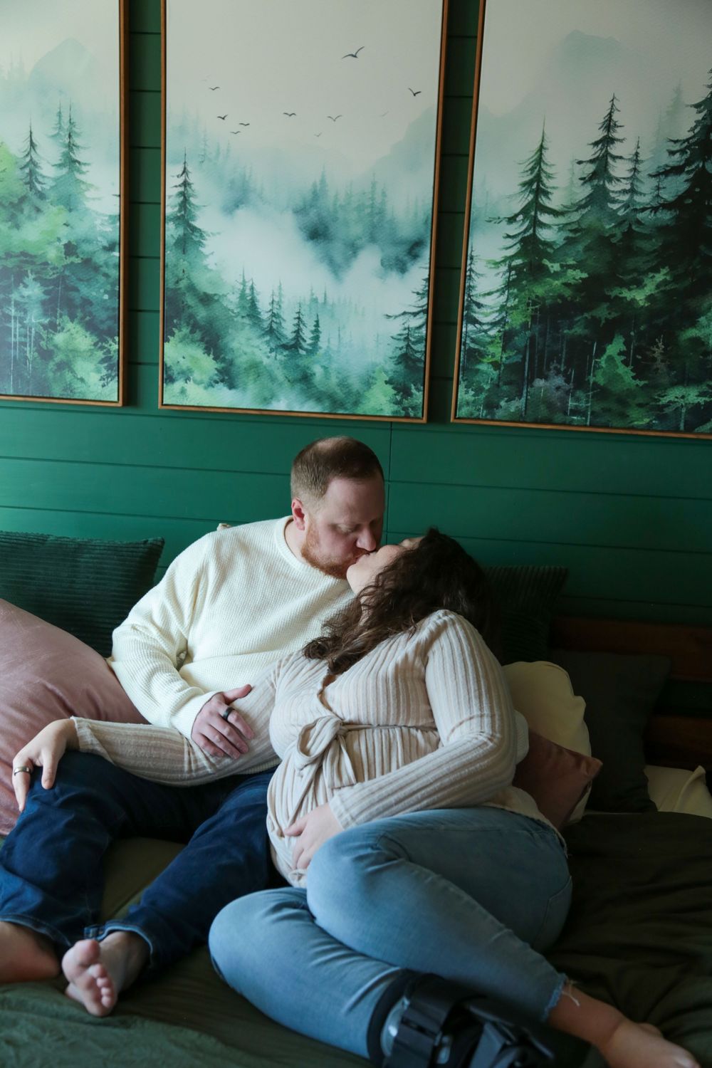 Husband and wife kissing on their bed.