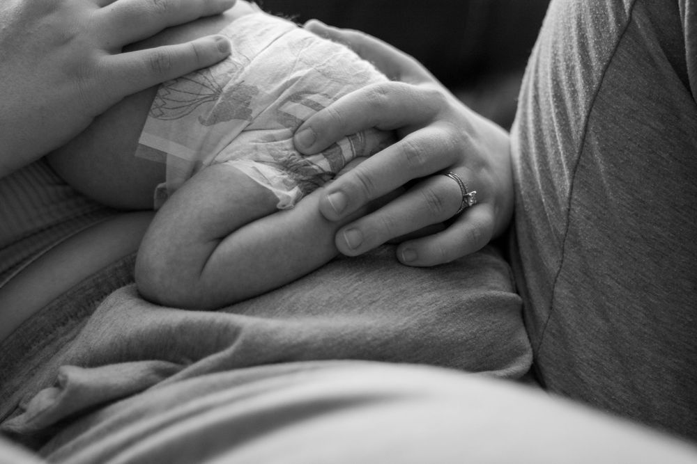 Mother holding newborn.