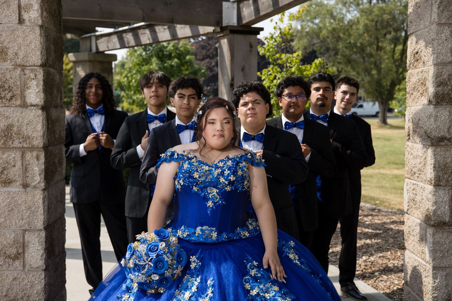 Quinceañera Jocelyn with chambelanes at Independence Grove Park. Professional Mis XV group portraits in Lake County by Alex T Photography.