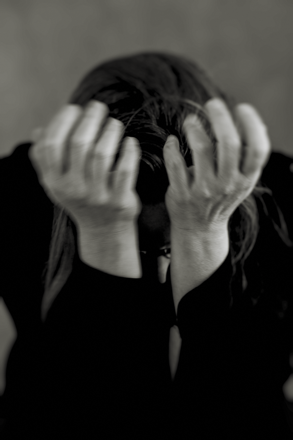 A sequence of black and white photos showing hands covering eyes in a dramatic gesture.