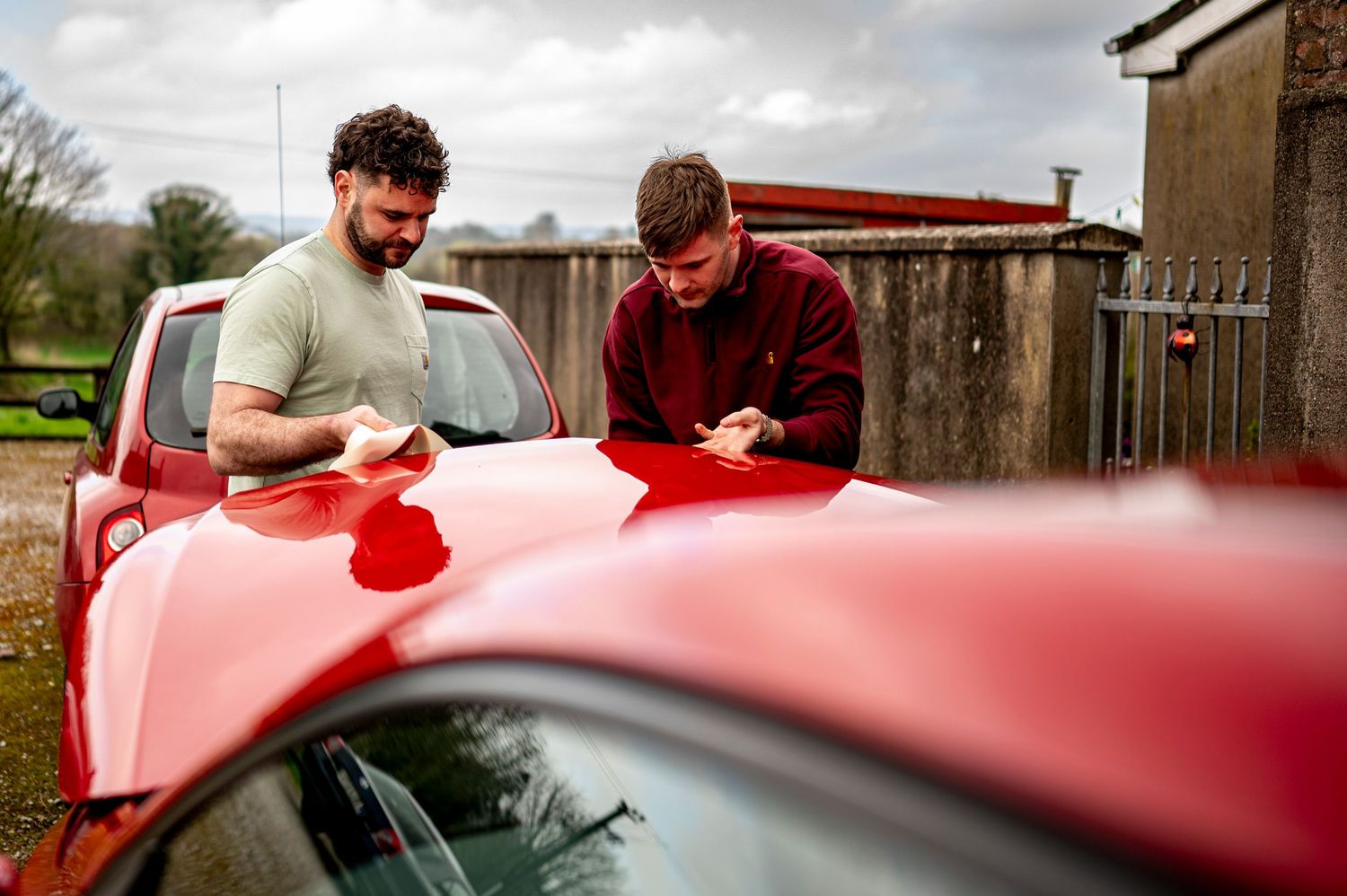 eleanor barry photography newborn waterford munster maternity wedding groom shots boys fixing ribbon to the red car