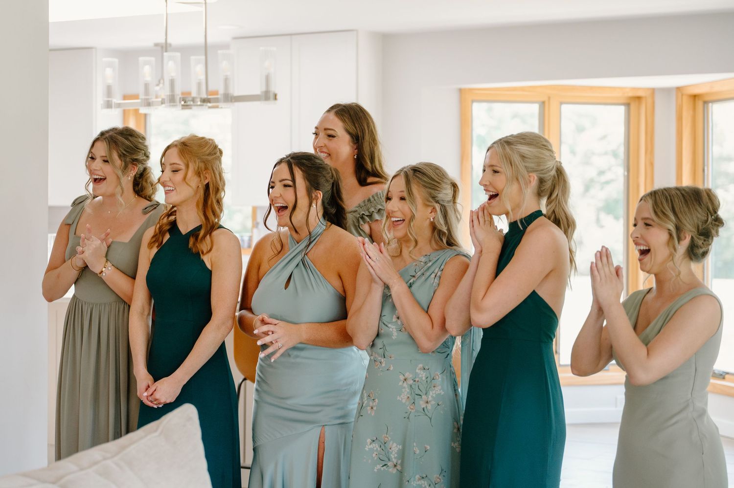 Bridesmaids in teal dresses react emotionally in sequence during a wedding reveal photo shoot.